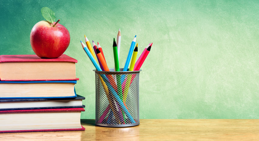 a red apple sitting on top a stack of 5 books next to a stack of pencils in a cup
